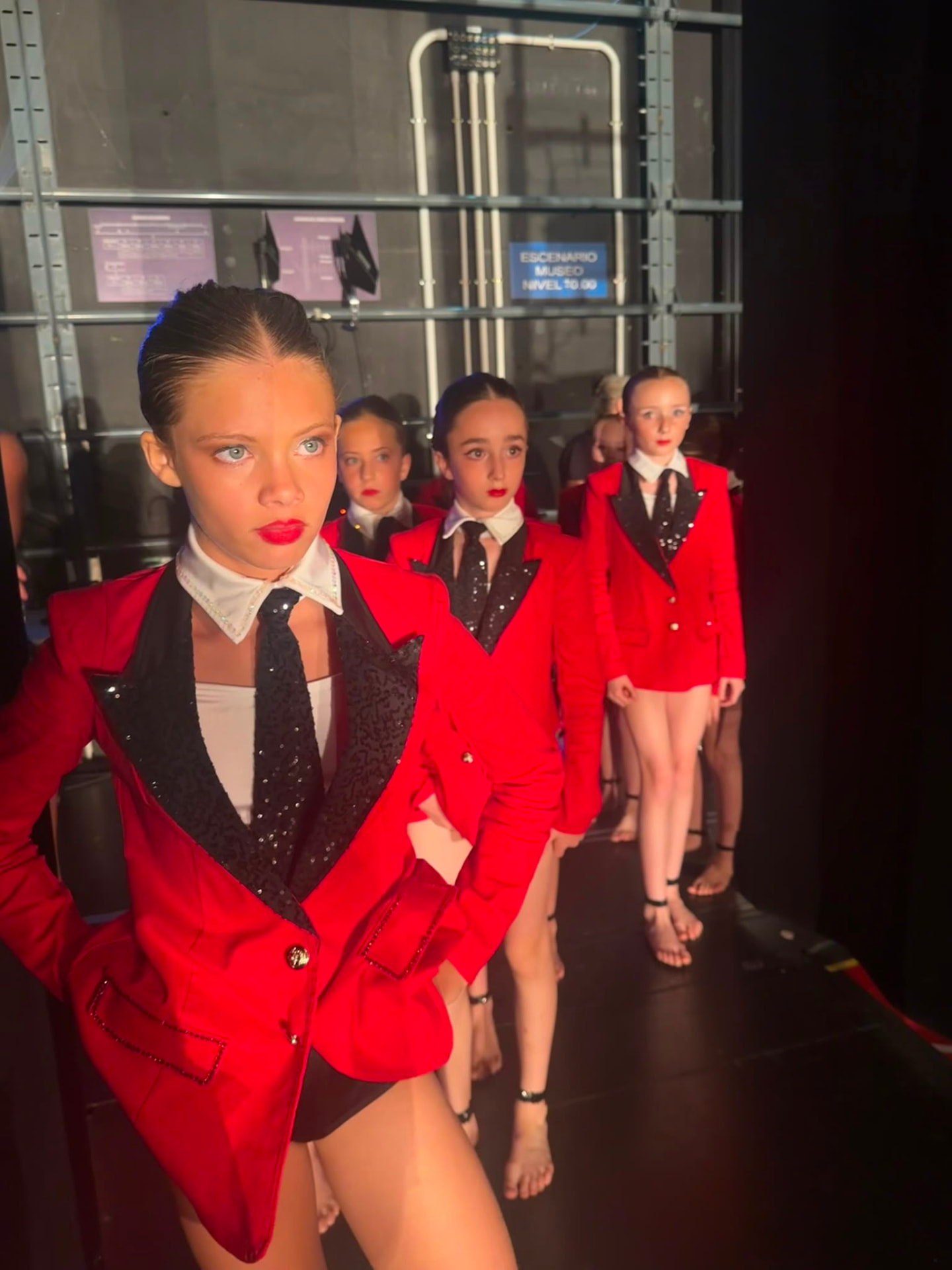 Moondance competition team in red jackets waiting backstage