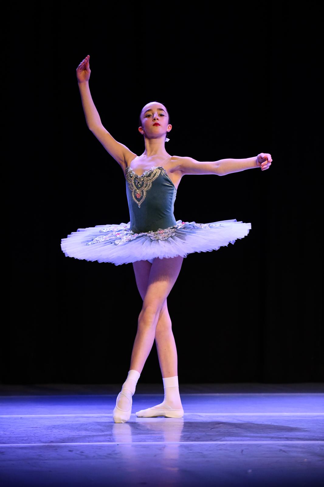 Moondance ballet dancer posing in a decorated tutu on stage